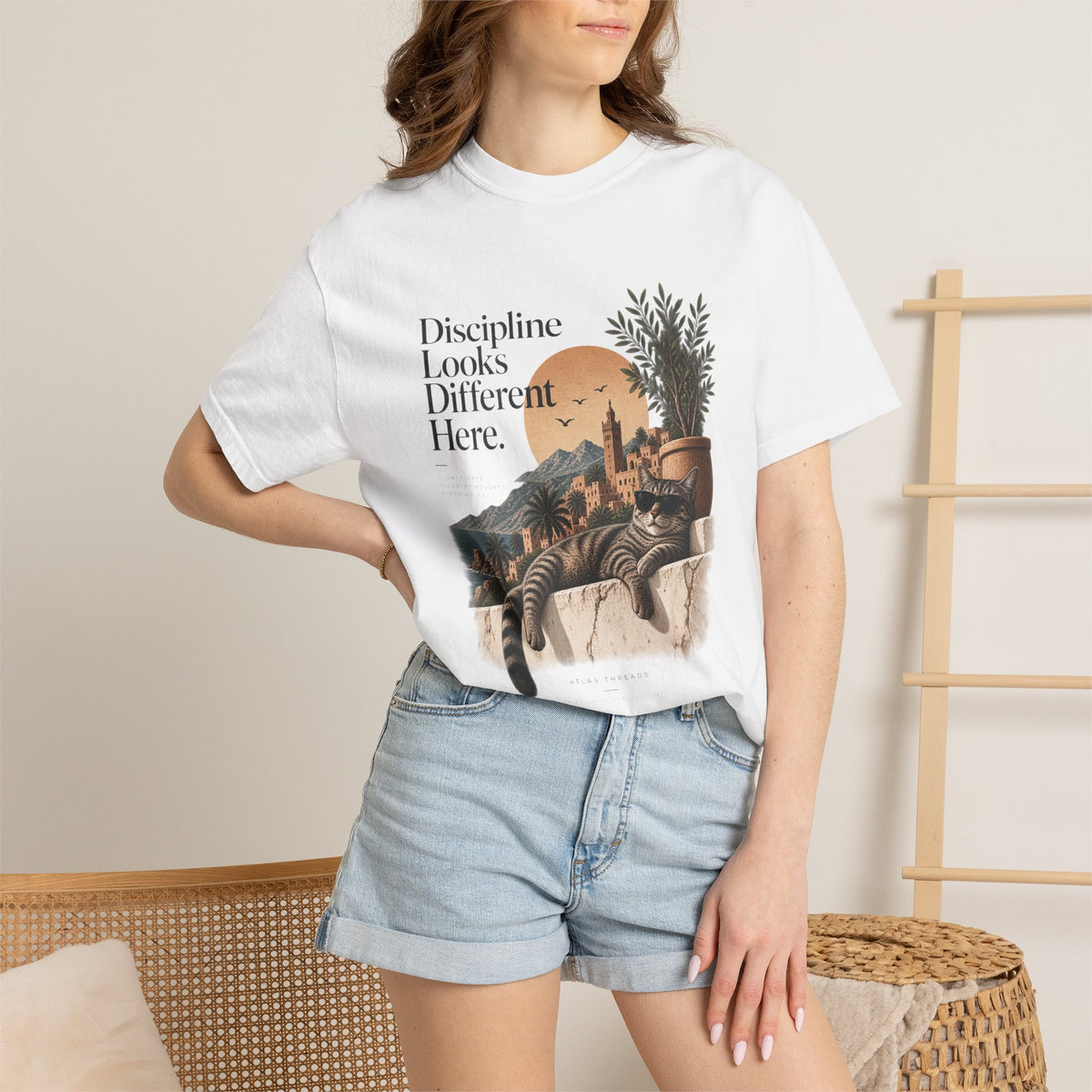 T-Shirt — "Discipline Looks Different Here" Sunset Cat Graphic