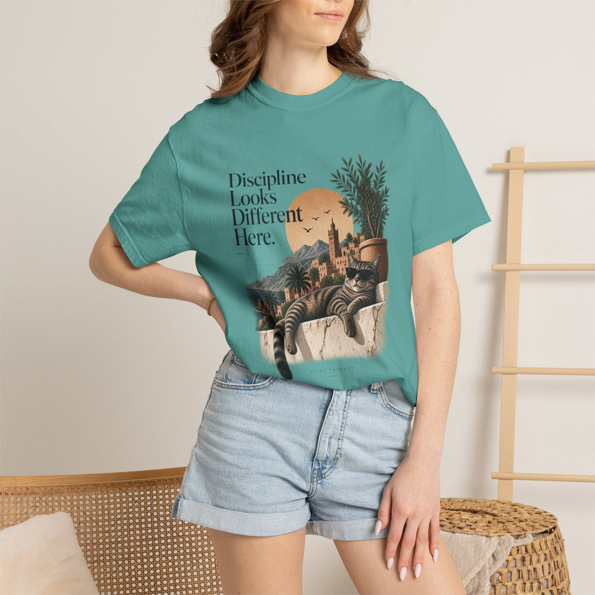 T-Shirt — "Discipline Looks Different Here" Sunset Cat Graphic