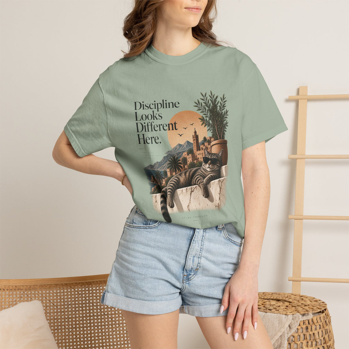 T-Shirt — "Discipline Looks Different Here" Sunset Cat Graphic